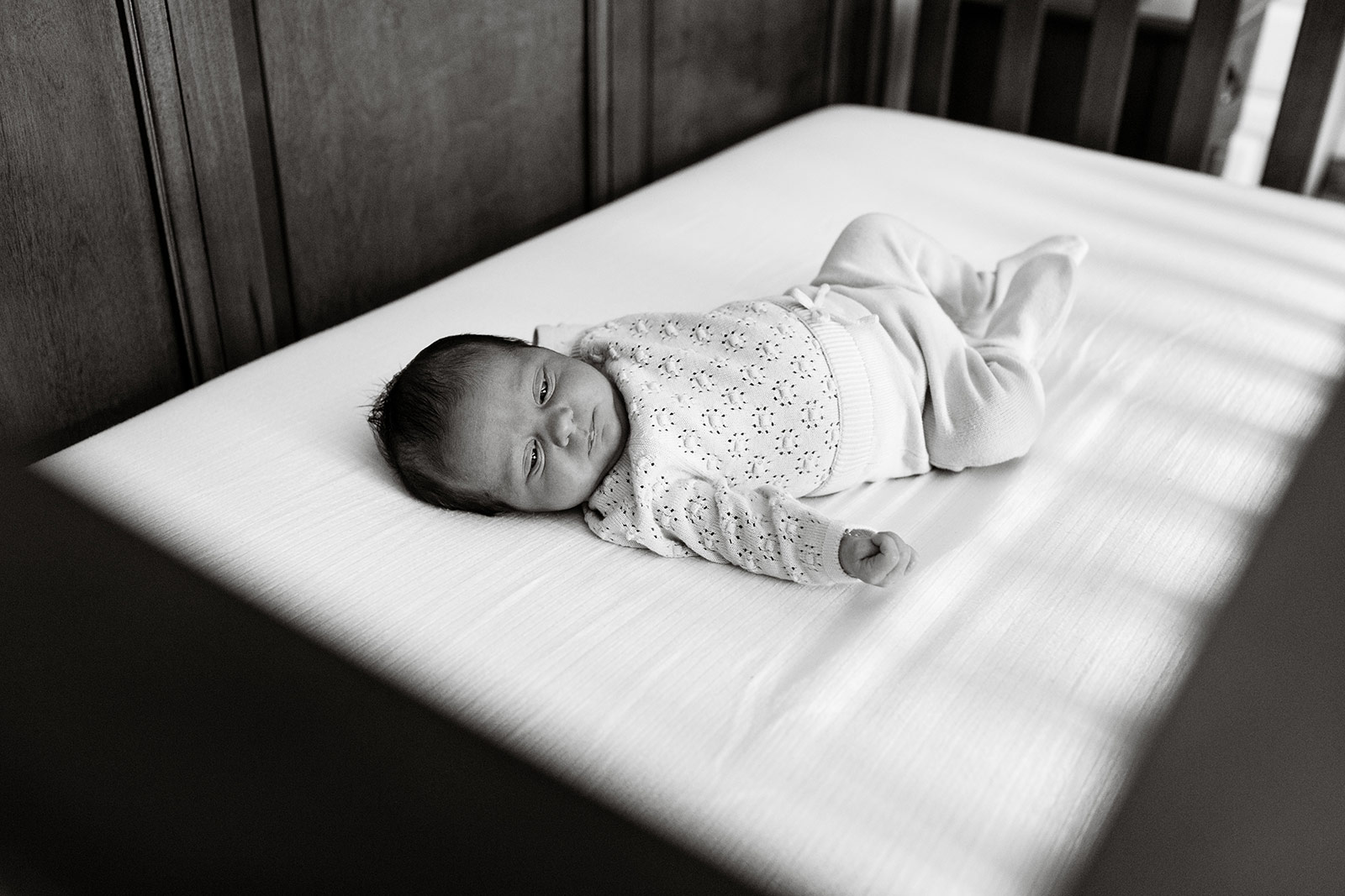 Baby Quinn rests in her crib.