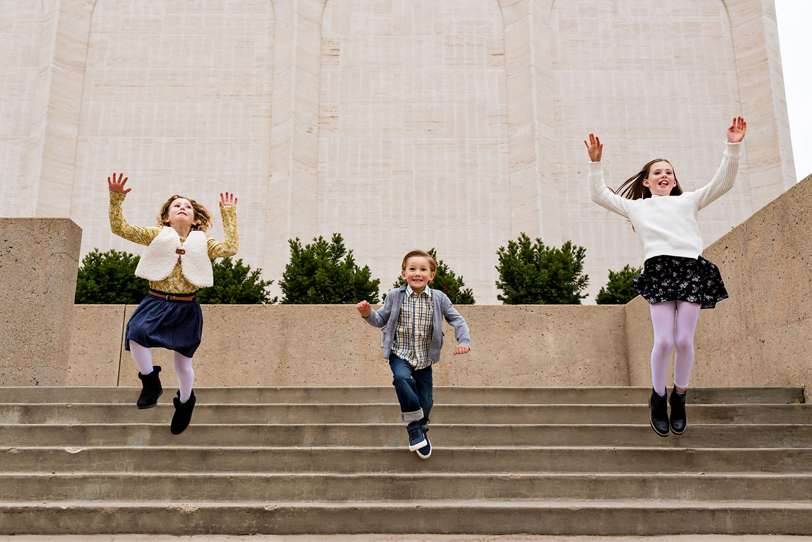Nora, Ben and Harper are caught jumping in mid-air from a set of steps.