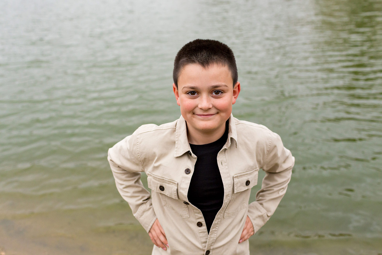 Eli poses confidently for a portrait with the soft shades of the water for a backdrop.