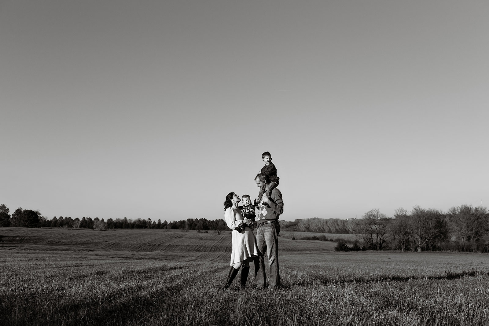 Black and white wide image of the family on their land.